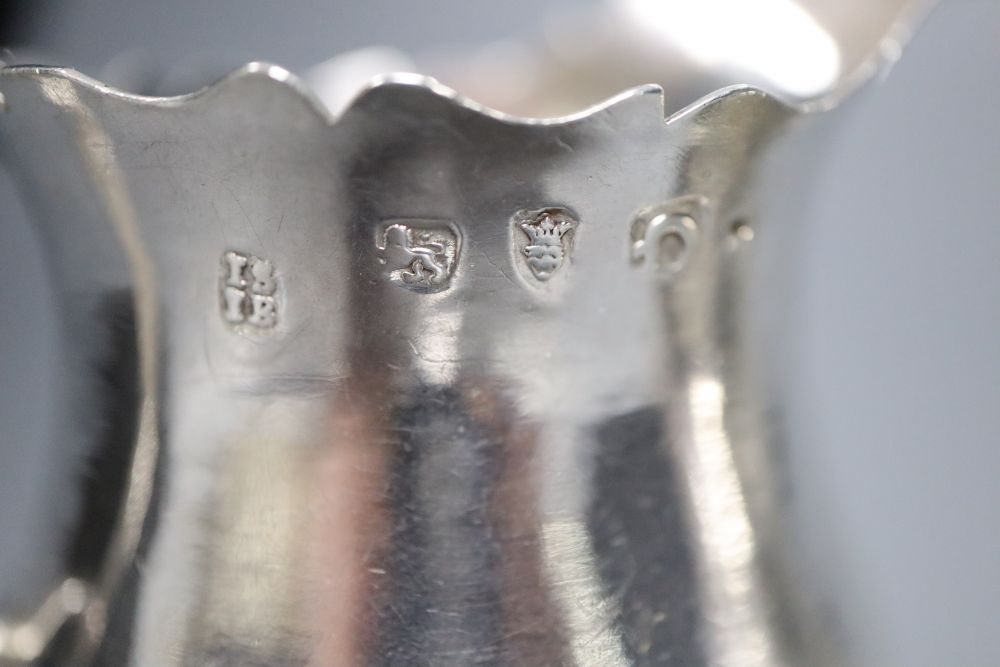 A late George II silver inverted pear shaped cream jug, Stamp & Baker, London, 1759 & one other cream jug.